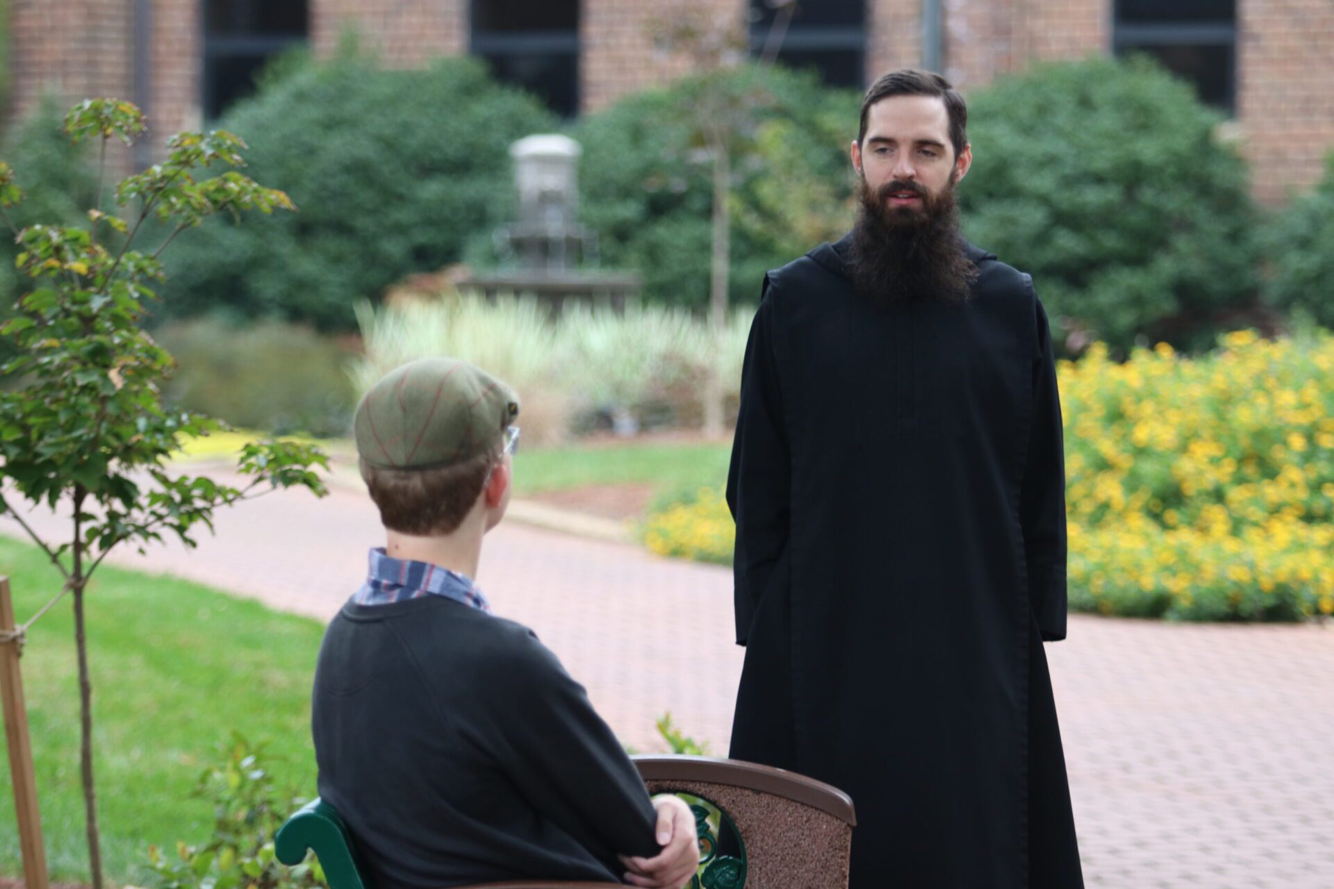 Belmont Abbey priest engaging in conversation on a walk